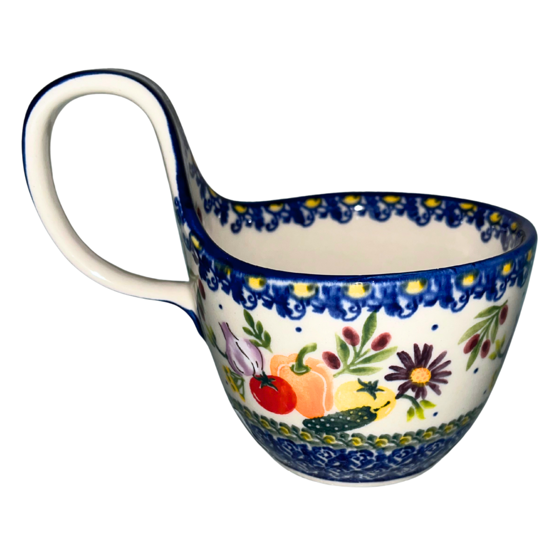 Handmade Polish Pottery loop-handled bowl by Ceramika Kalich decorated in Vegetables pattern with colorful garden vegetables and flowers, bordered in cobalt blue and yellow