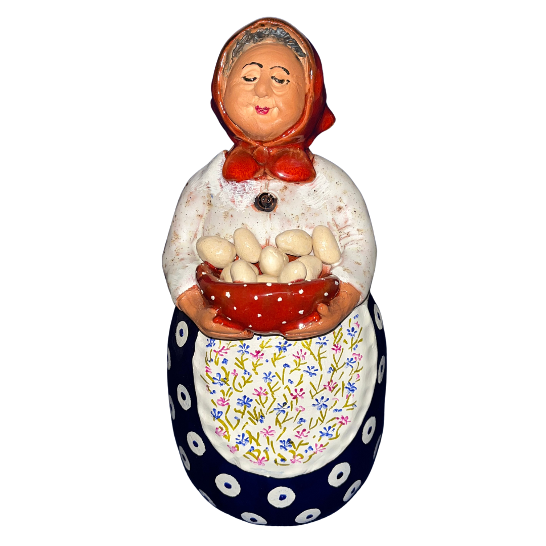 Hand-painted folk art babcia grannie figurine holding a bowl of fresh eggs