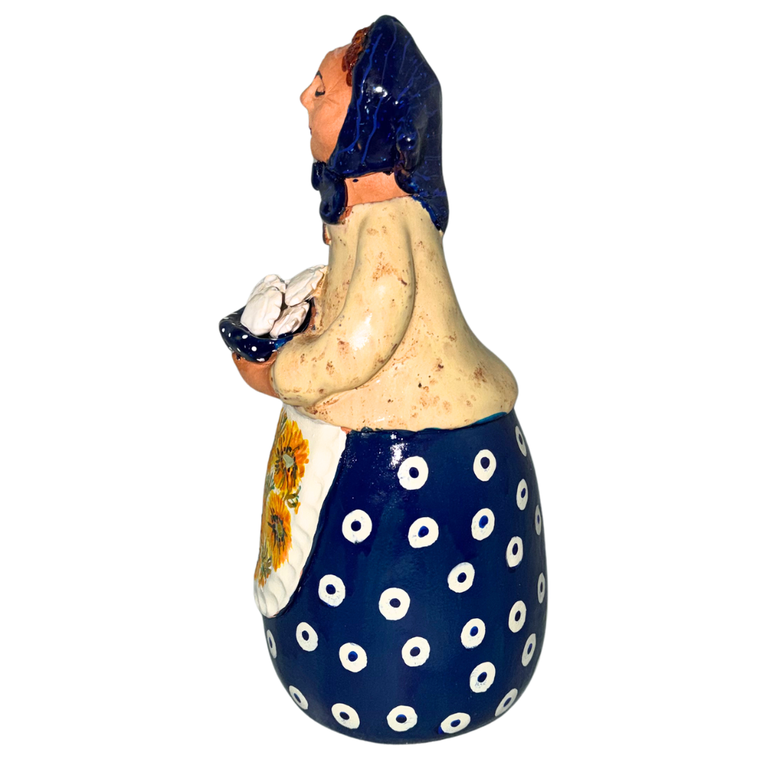 Hand-painted handcrafted babcia figurine holding a bowl of pierogi.
