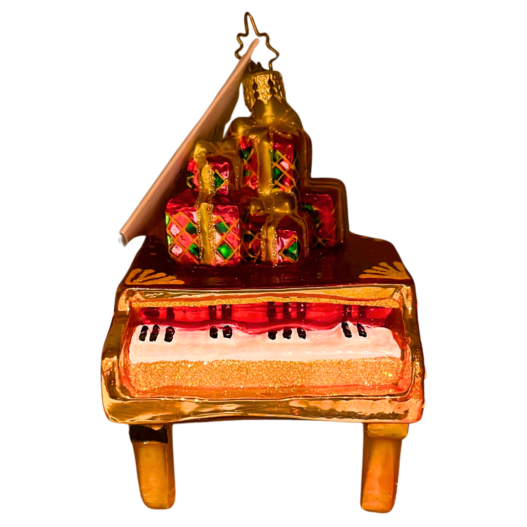 Elegant grand piano topped with glittering gift boxes. Handcrafted, hand-painted Christopher Radko glass ornament made in Poland — perfect for music lovers and collectors.