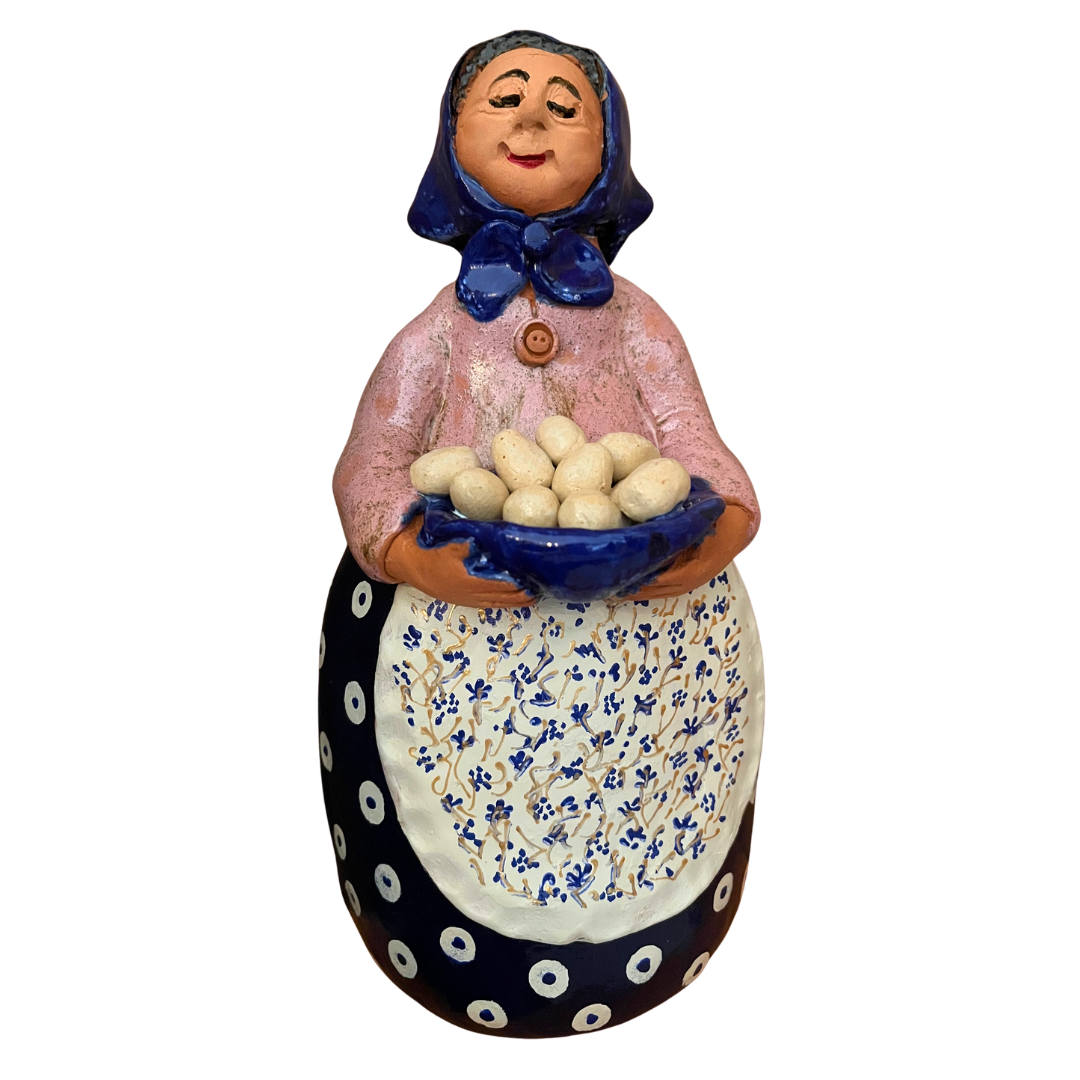 Hand-painted folk art babcia grannie figurine holding a bowl of fresh eggs