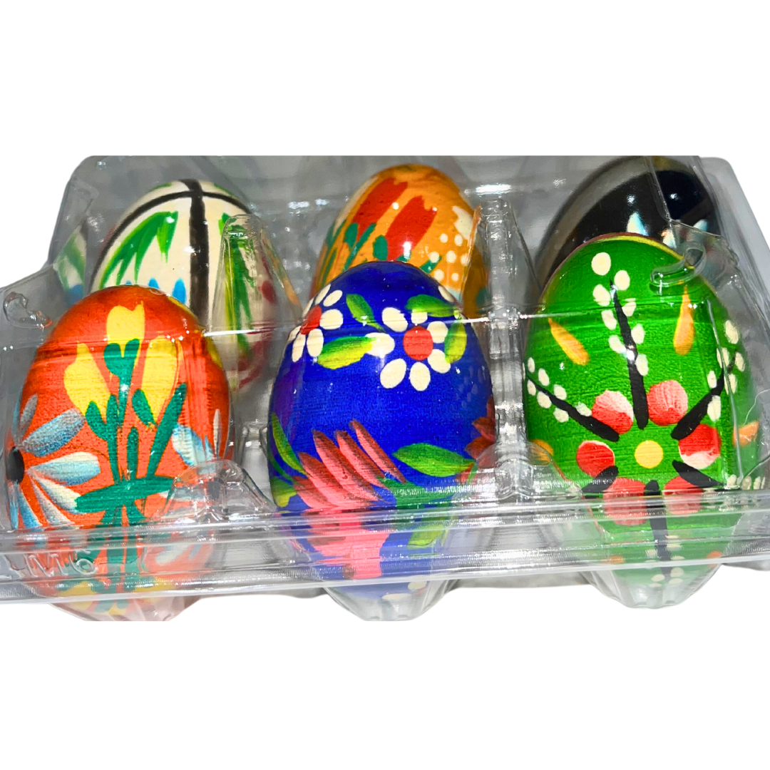 Traditional Polish Pisanki hand-painted wooden eggs featuring colorful folk designs, flowers, and birds. Beautiful Easter decorations and collectible Polish folk art.