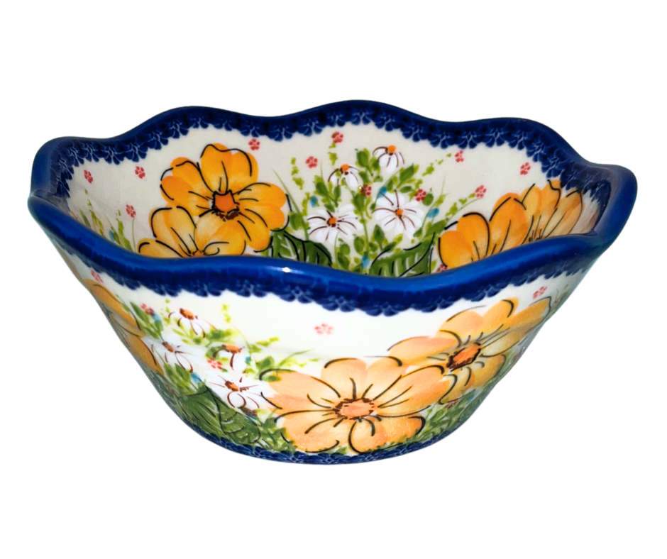 Kalich Polish Pottery floral pattern with golden yellow blossoms, white accents, and green foliage on cream with cobalt rim; hand-painted meadow design with light, airy composition