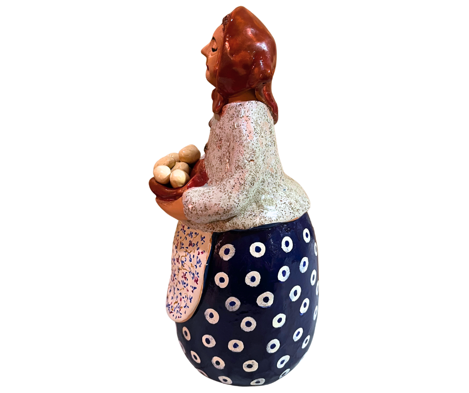 Hand-painted babcia grannie figurine holding a bowl of fresh eggs, wearing an aqua scarf and floral apron