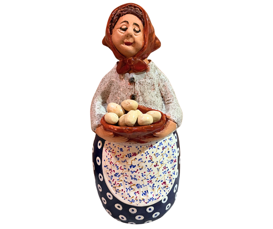 Hand-painted babcia grannie figurine holding a bowl of fresh eggs, wearing an aqua scarf and floral apron