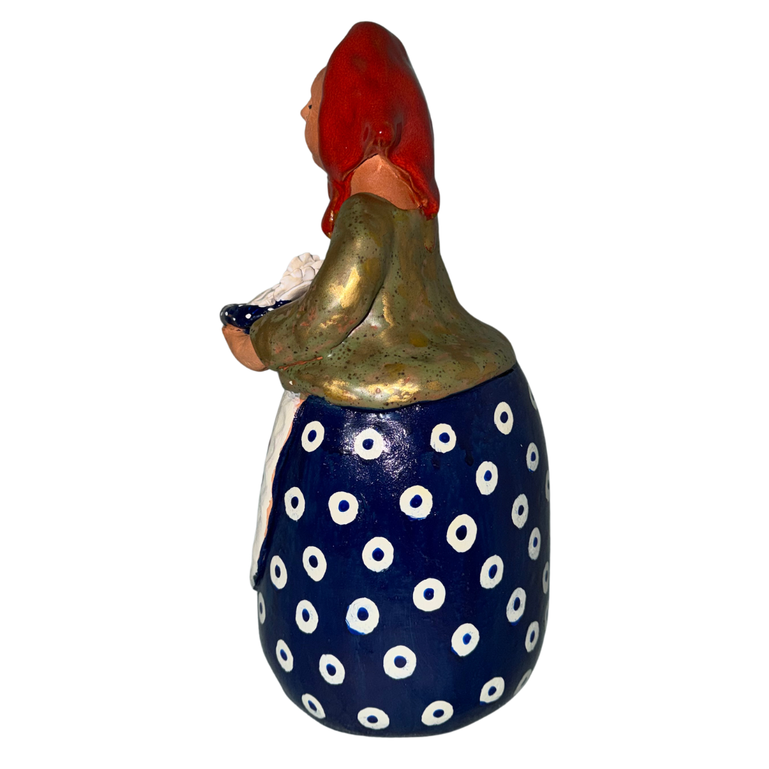 Hand-painted handcrafted babcia figurine holding a bowl of pierogi.