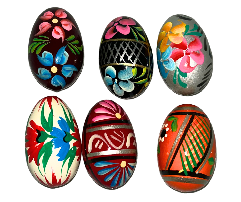 Traditional Polish Pisanki hand-painted wooden eggs featuring colorful folk designs, flowers, and birds. Beautiful Easter decorations and collectible Polish folk art.