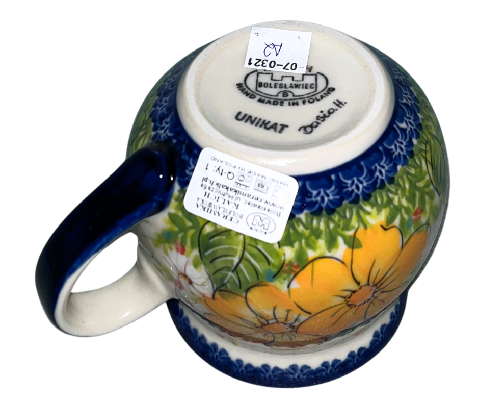 Kalich Polish Pottery floral pattern with golden yellow blossoms, white accents, and green foliage on cream with cobalt rim; hand-painted meadow design with light, airy composition.
