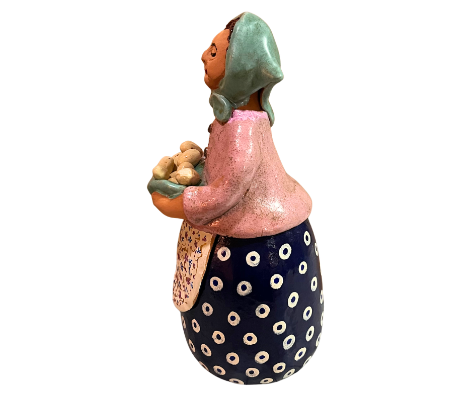 Hand-painted babcia grannie figurine holding a bowl of fresh eggs, wearing an aqua scarf and floral apron
