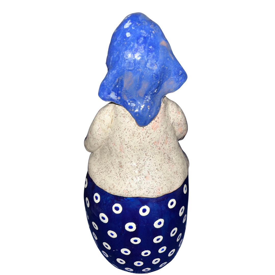 Hand-painted folk art babcia grannie figurine holding a bowl of fresh eggs