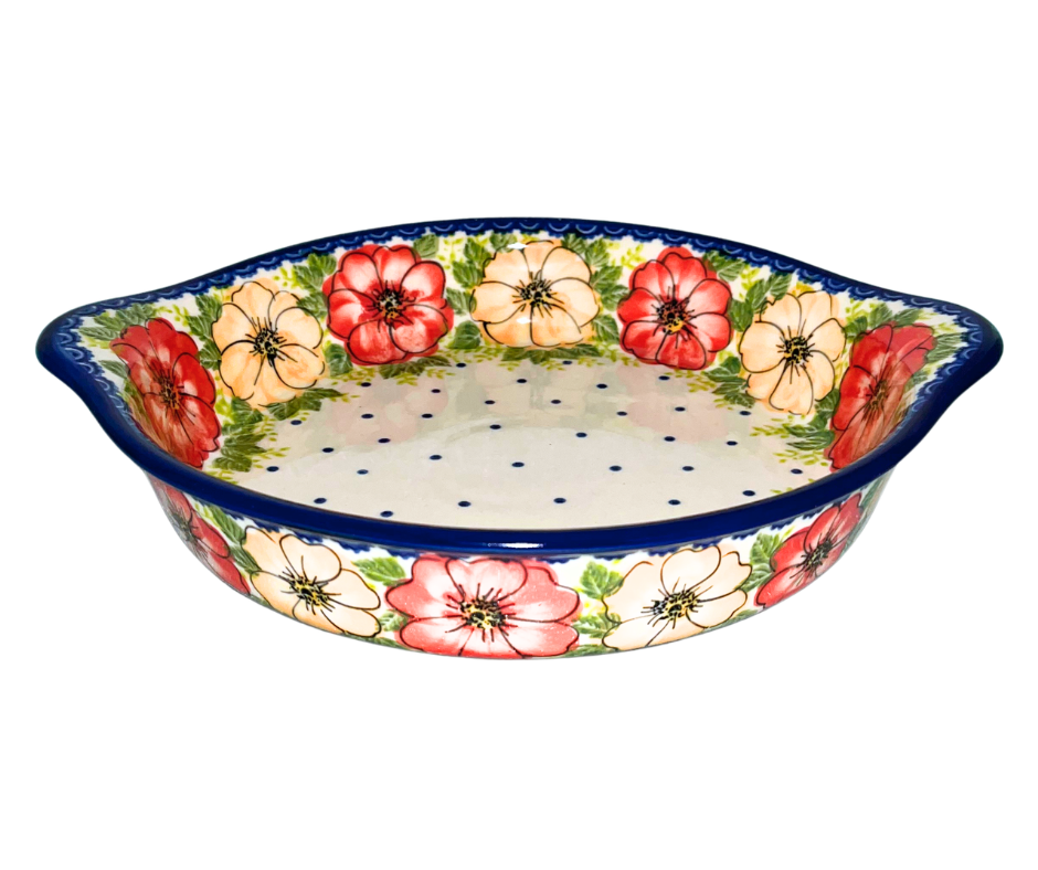 Kalich Polish Pottery floral pattern with red and yellow blossoms, white accents, and green foliage on cream with cobalt rim; hand-painted meadow design with light, airy composition.