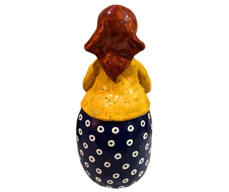 Hand-painted babcia figurine holding a bowl of pierogi, wearing a red scarf and floral apron