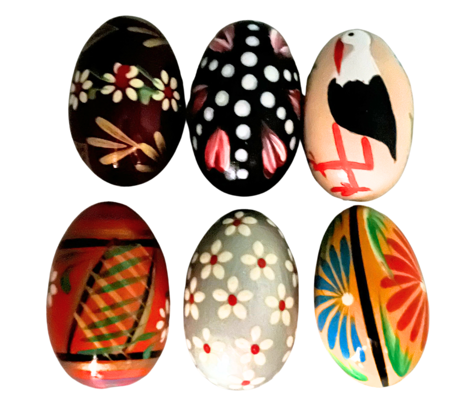 Traditional Polish Pisanki hand-painted wooden eggs featuring colorful folk designs, flowers, and birds. Beautiful Easter decorations and collectible Polish folk art.