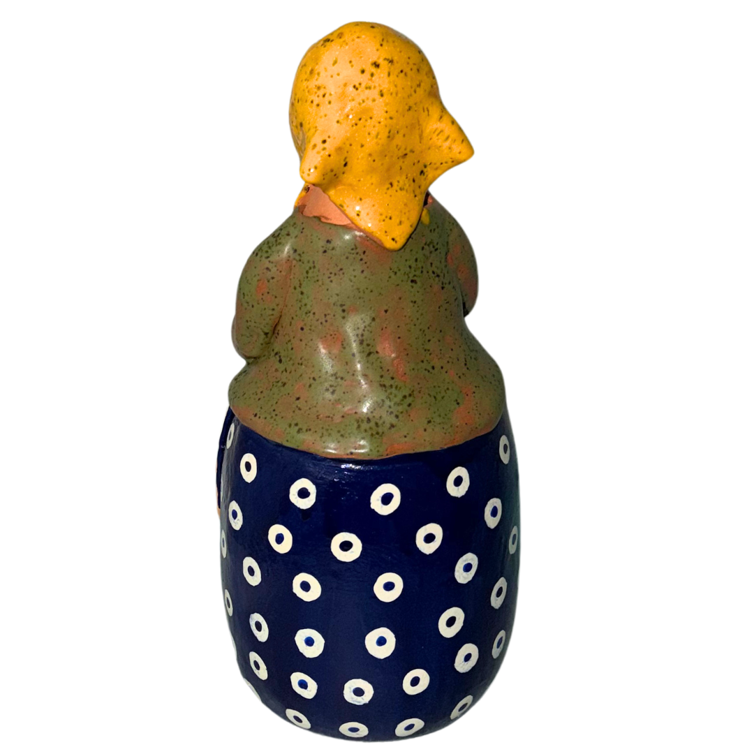 Hand-painted handcrafted babcia figurine holding a bowl of pierogi.