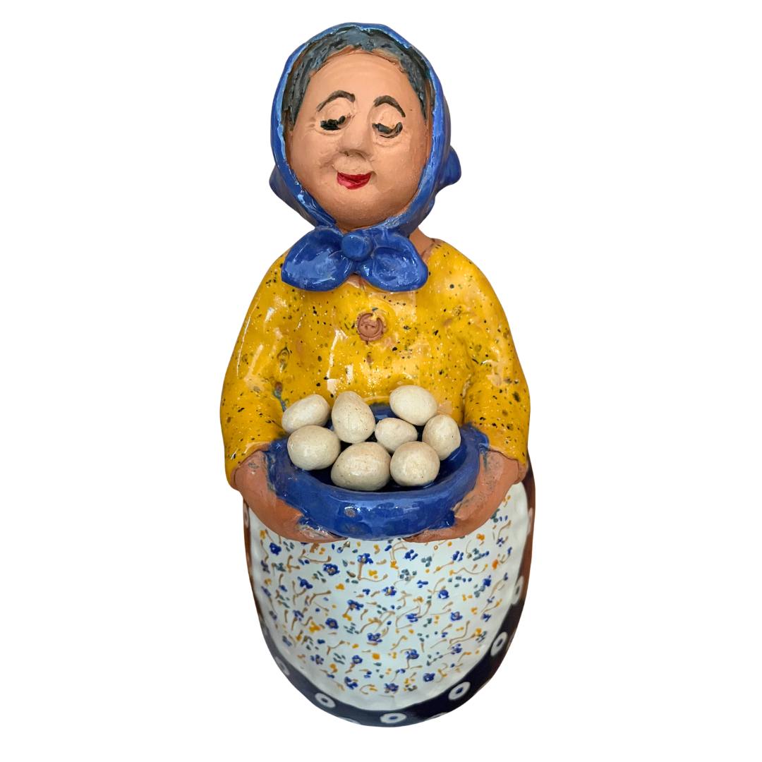 Hand-painted folk art babcia grannie figurine holding a bowl of fresh eggs