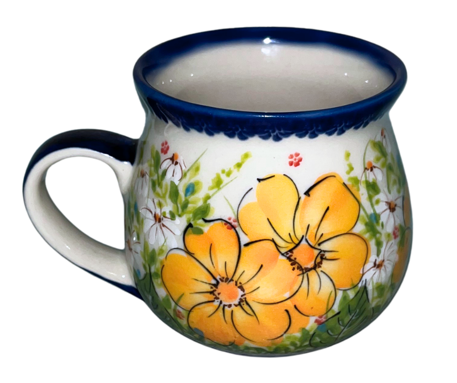 Kalich Polish Pottery floral pattern with golden yellow blossoms, white accents, and green foliage on cream with cobalt rim; hand-painted meadow design with light, airy composition.