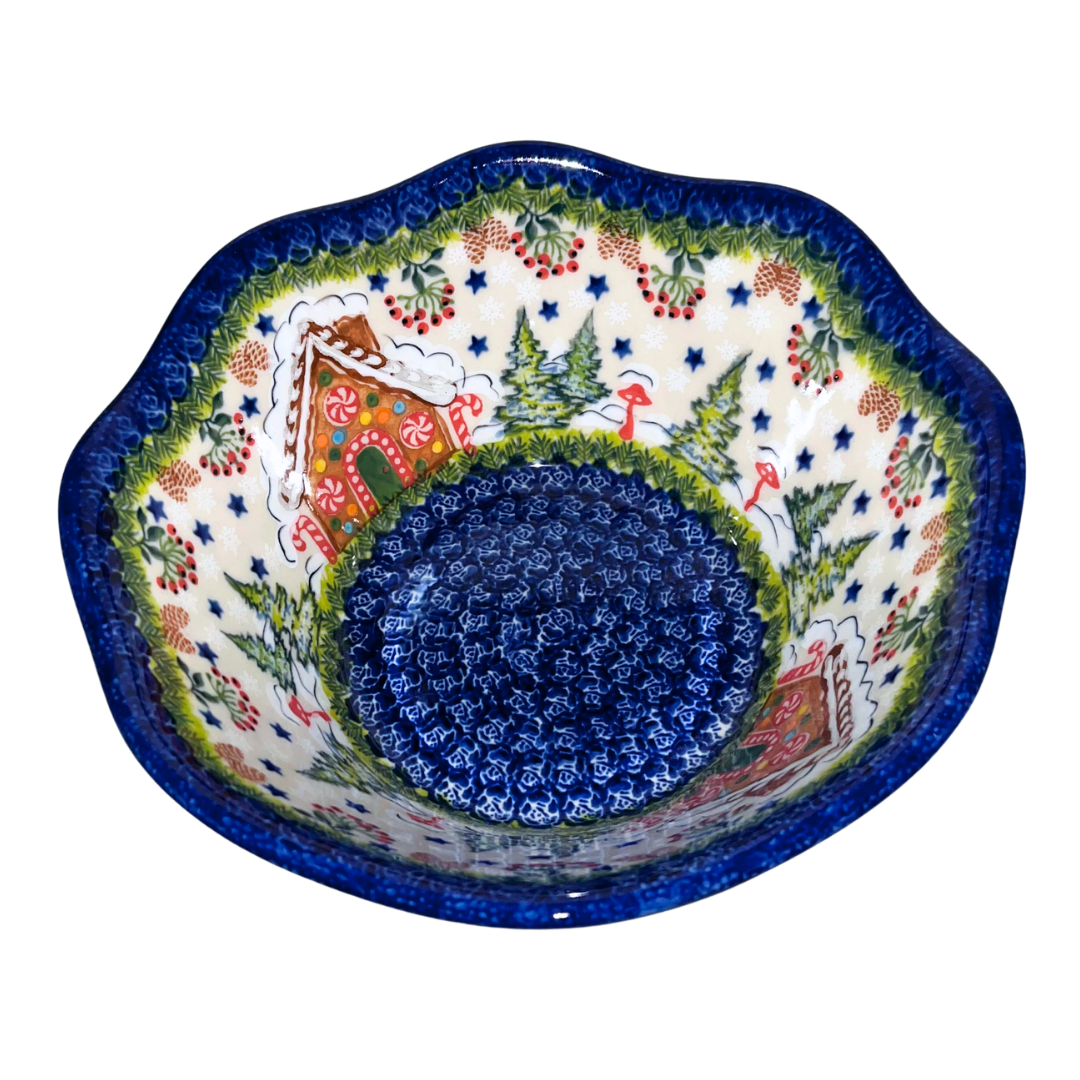 Hand-painted ceramic mug featuring a festive gingerbread cottage surrounded by evergreen branches, berries, and holiday stars. Durable, functional art—perfect for coffee,