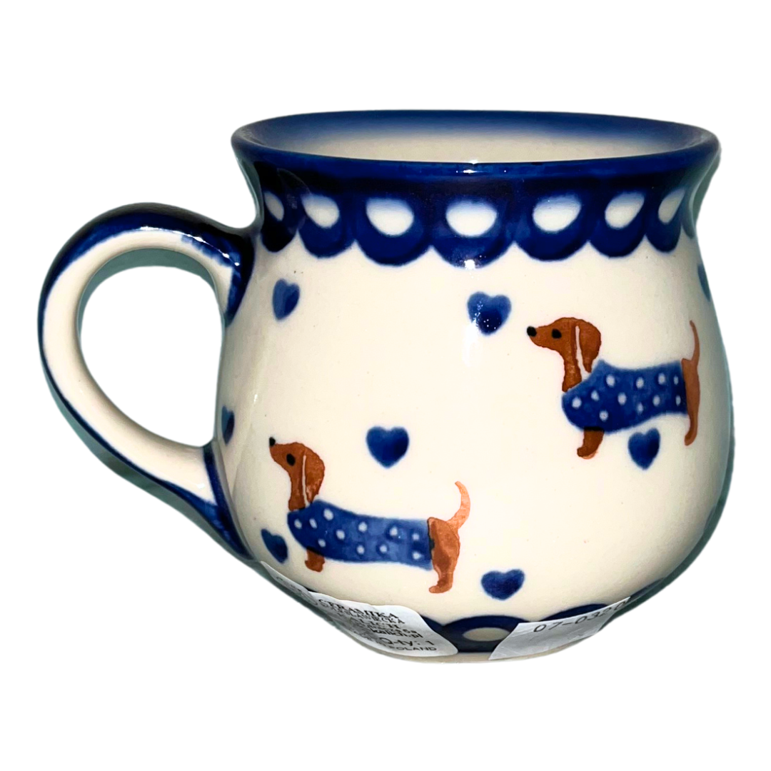 Ceramika Kalich Pattern 1322 Dachshunds features playful dachshunds in blue coats with scattered blue hearts and cobalt accents. Hand-painted Polish pottery from Poland.