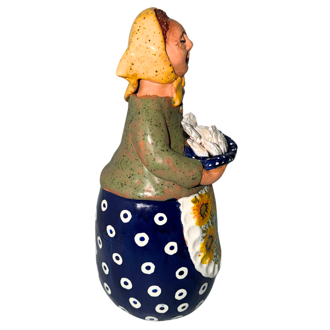 Hand-painted handcrafted babcia figurine holding a bowl of pierogi.