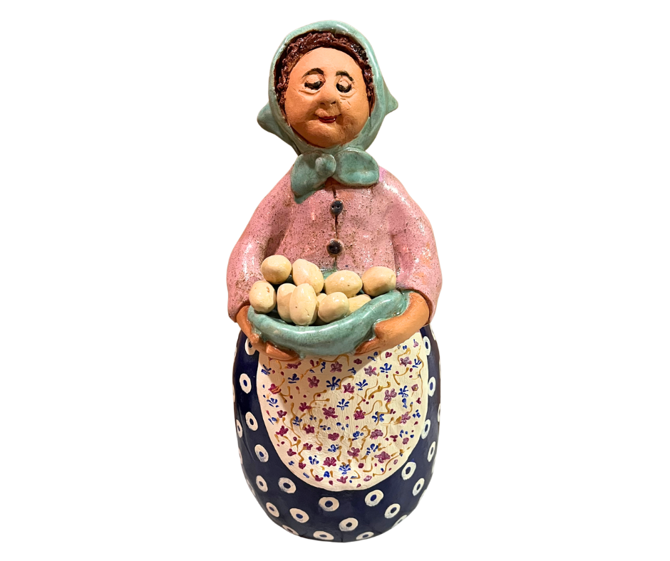 Hand-painted babcia grannie figurine holding a bowl of fresh eggs, wearing an aqua scarf and floral apron