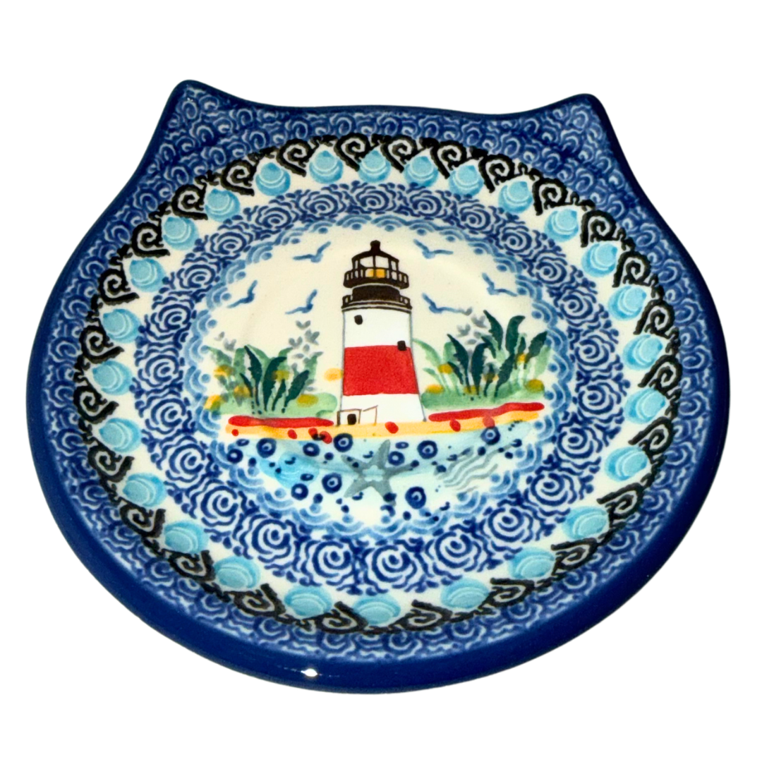 Ceramika Artystyczna U5220 Polish Pottery saucer featuring a hand-painted red and white lighthouse, coastal grasses, seabirds and cobalt blue waves.