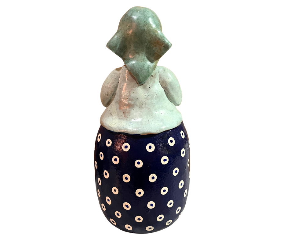 Charming hand-painted “Babcia Holding a Book” figurine featuring a Polish grandmother in an aqua scarf and floral apron. A heartwarming gift and beautiful piece of folk-inspired home décor.