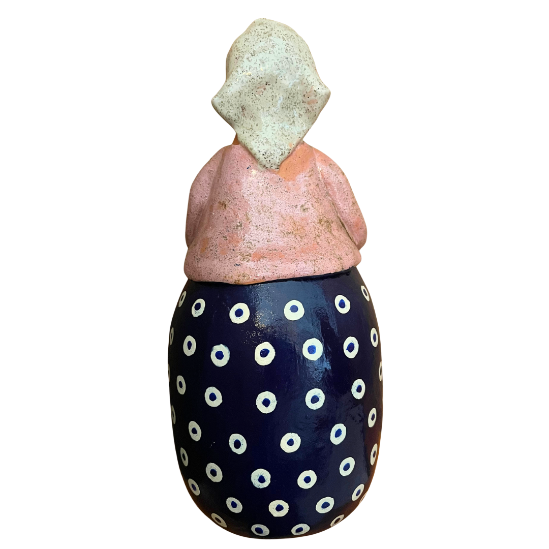 Hand-painted folk art babcia grannie figurine holding a bowl of fresh eggs