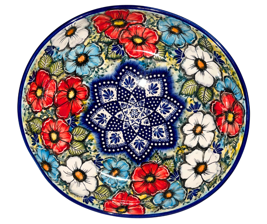 Limited edition 12.25x12.5x3.25 ceramic bowl by Kaola Studio, signed by Aga K. Features red, white & blue florals with cobalt mandala center. Handmade in Poland.