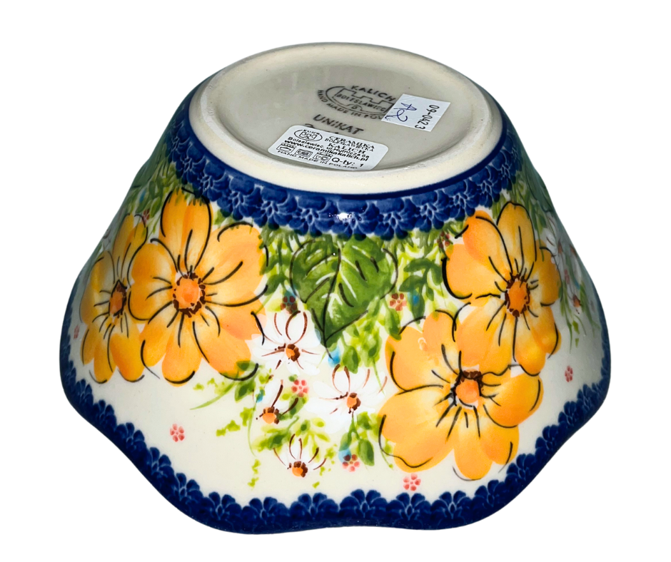 Kalich Polish Pottery floral pattern with golden yellow blossoms, white accents, and green foliage on cream with cobalt rim; hand-painted meadow design with light, airy composition