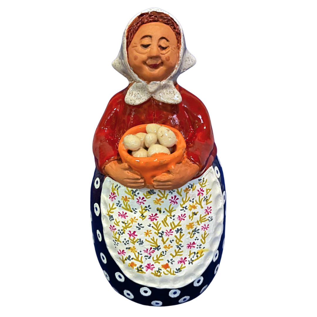 Hand-painted folk art babcia grannie figurine holding a bowl of fresh eggs
