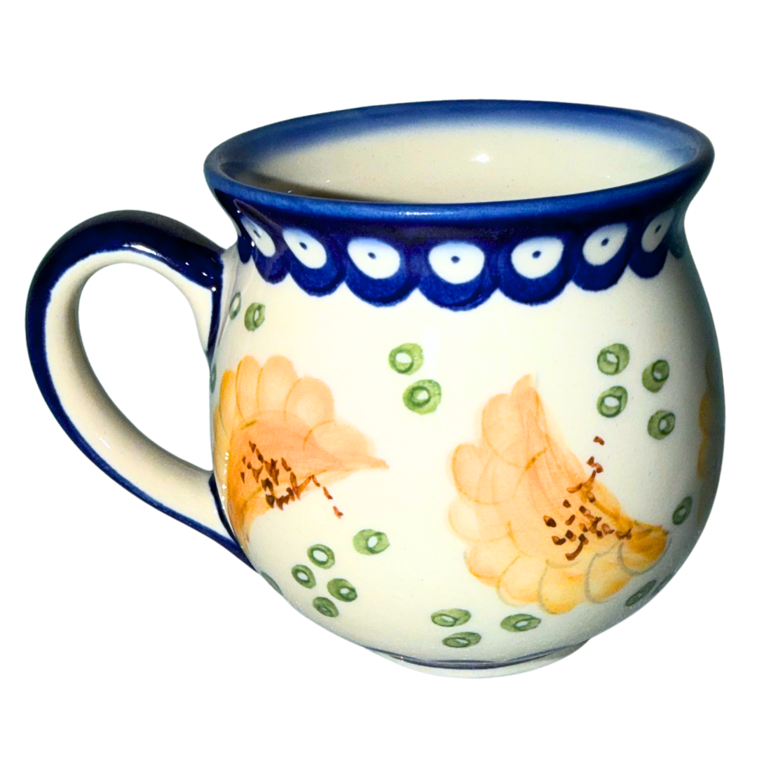 Ceramika Kalich Polish Pottery Pattern 1447 Pierogis bubble mug, hand-painted with golden pierogi, green accents and a cobalt blue border.