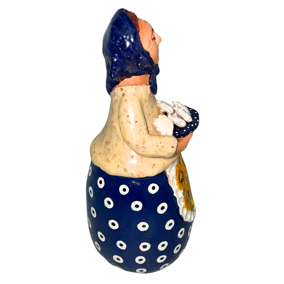 Hand-painted handcrafted babcia figurine holding a bowl of pierogi.