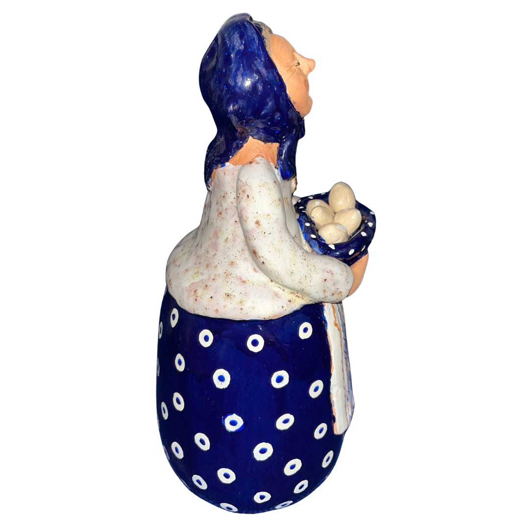 Hand-painted folk art babcia grannie figurine holding a bowl of fresh eggs