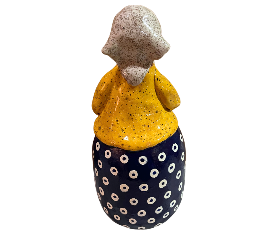 Hand-painted babcia grannie figurine holding a bowl of fresh eggs, wearing a tan scarf and floral apron
