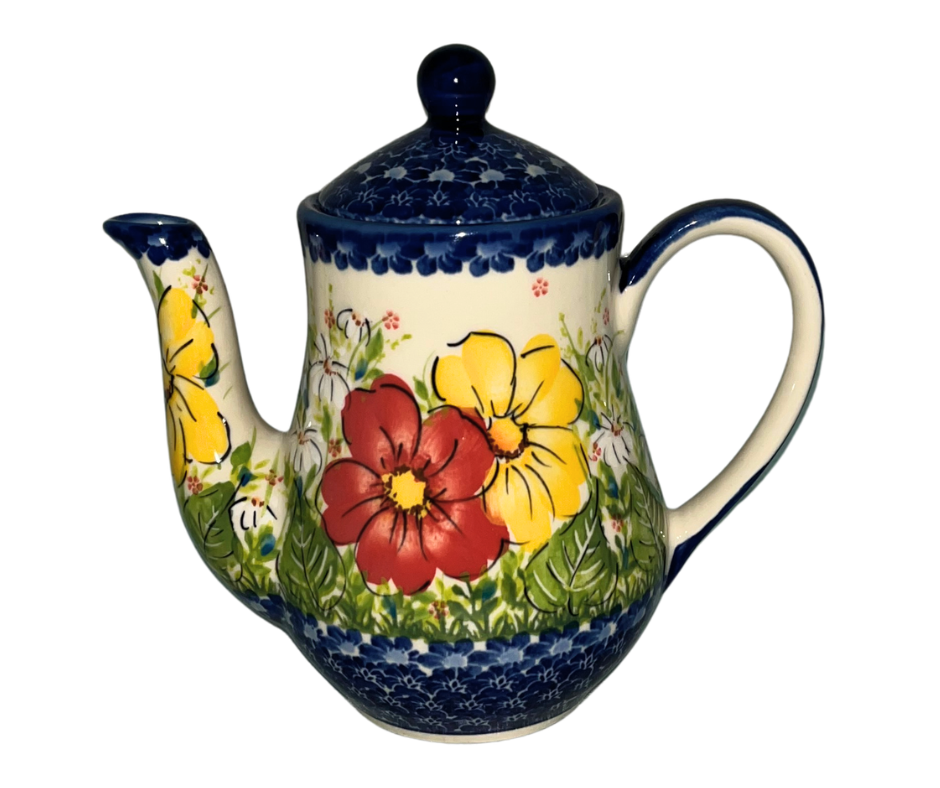 Kalich Polish Pottery floral pattern with red and yellow blossoms, white accents, and green foliage on cream with cobalt rim; hand-painted meadow design with light, airy composition