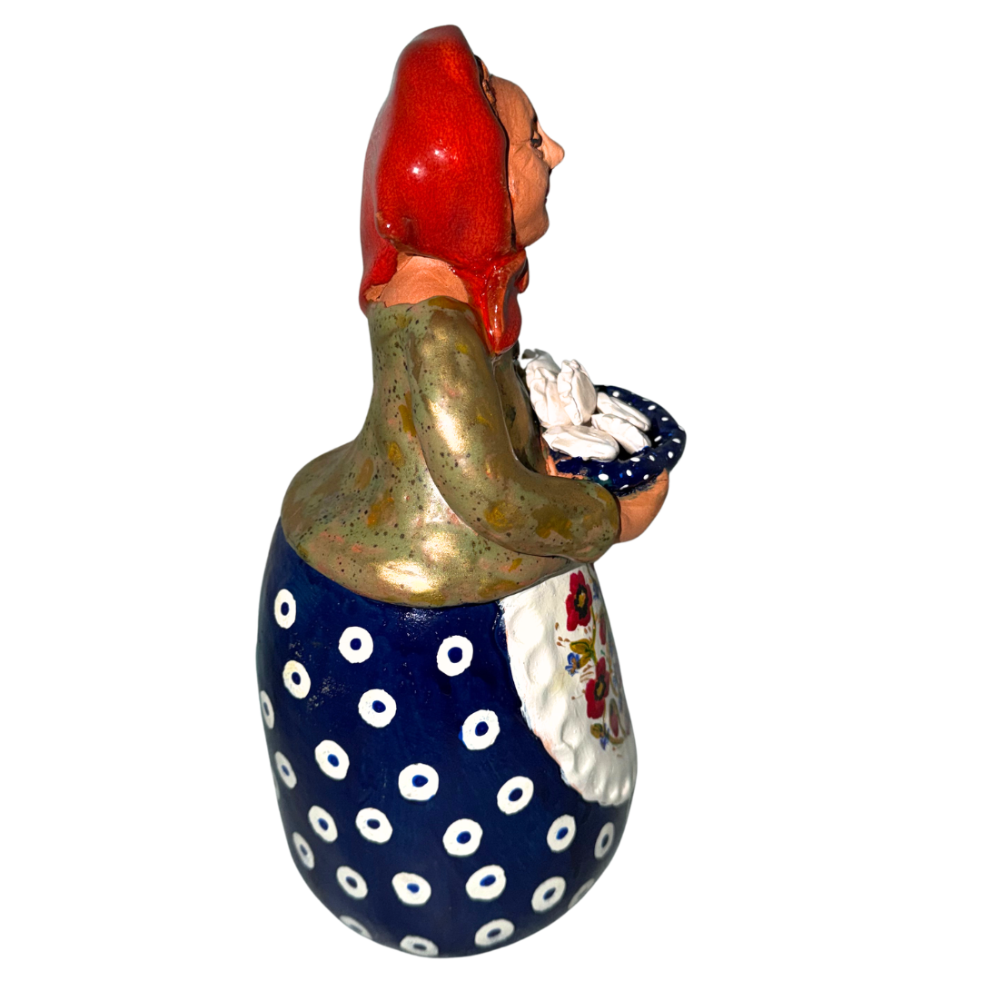 Hand-painted handcrafted babcia figurine holding a bowl of pierogi.
