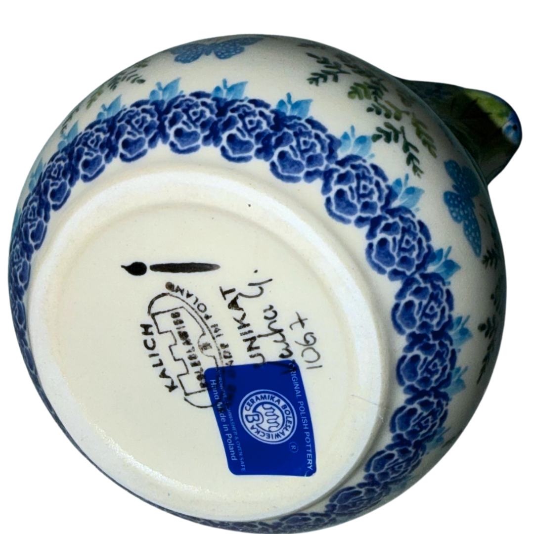 Ceramika Kalich Polish Pottery 24 oz Kubus pitcher with blue and white flowers, green foliage and butterflies, handcrafted in Bolesławiec, Poland.