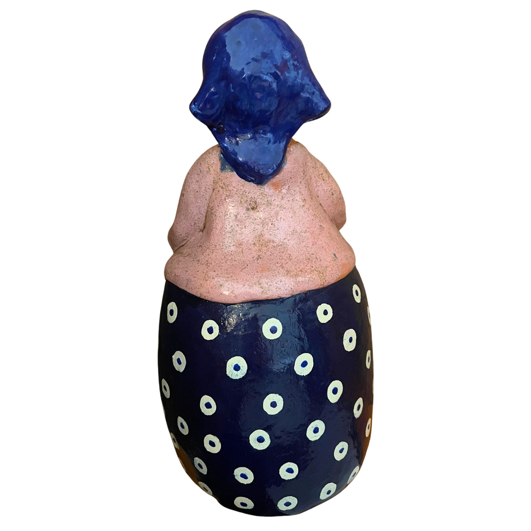 Hand-painted folk art babcia grannie figurine holding a bowl of fresh eggs