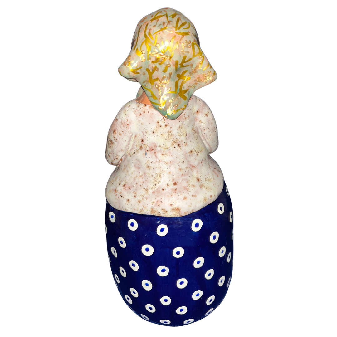 Hand-painted folk art babcia grannie figurine holding a bowl of fresh eggs