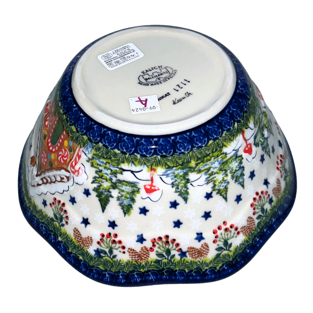 Hand-painted ceramic mug featuring a festive gingerbread cottage surrounded by evergreen branches, berries, and holiday stars. Durable, functional art—perfect for coffee,