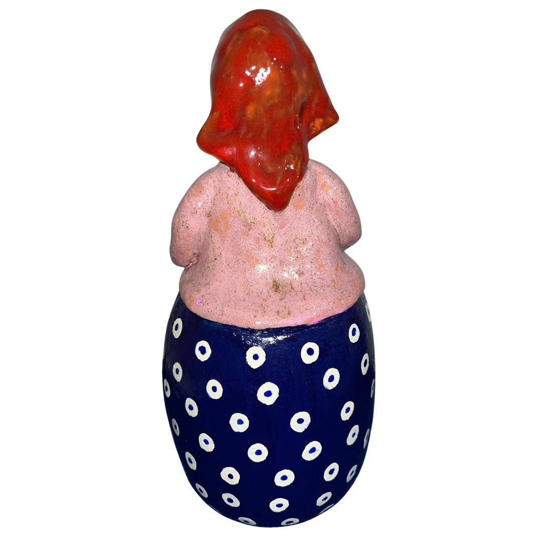 Charming hand-painted “Babcia Holding a Book” figurine featuring a Polish grandmother in an aqua scarf and floral apron. A heartwarming gift and beautiful piece of folk-inspired home décor.