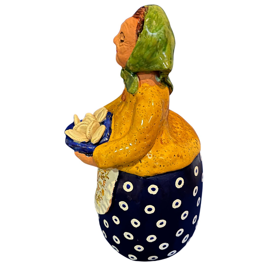 Hand-painted handcrafted babcia figurine holding a bowl of pierogi.