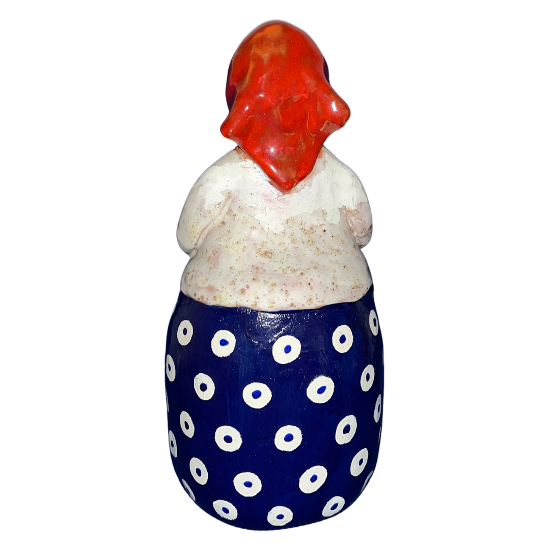 Hand-painted folk art babcia grannie figurine holding a bowl of fresh eggs