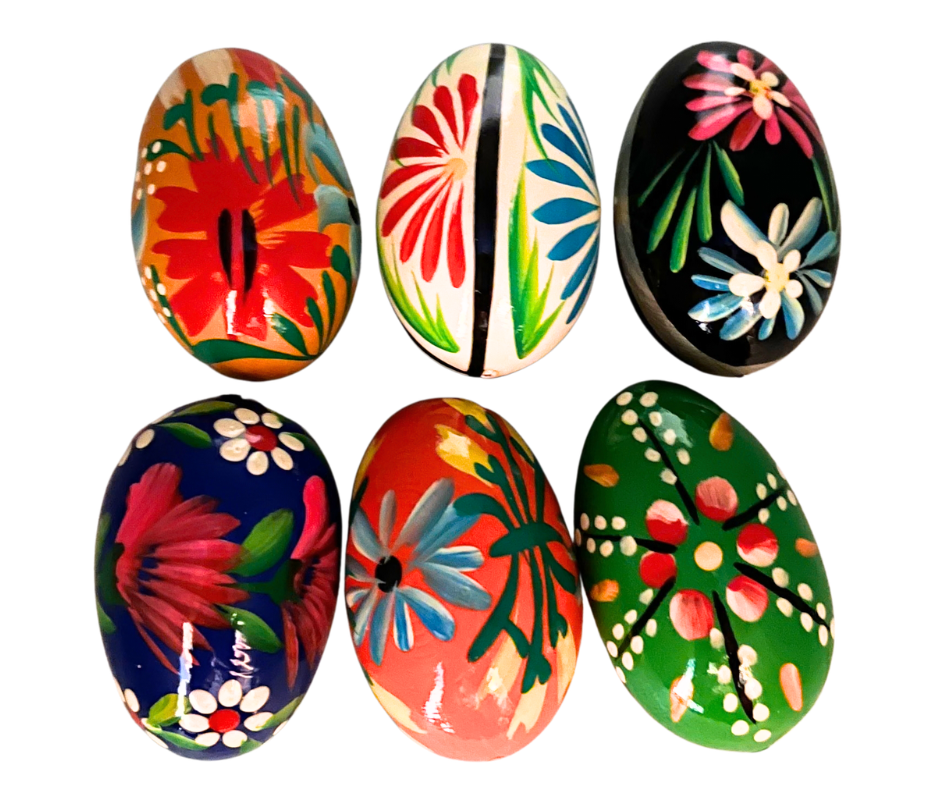 Traditional Polish Pisanki hand-painted wooden eggs featuring colorful folk designs, flowers, and birds. Beautiful Easter decorations and collectible Polish folk art.