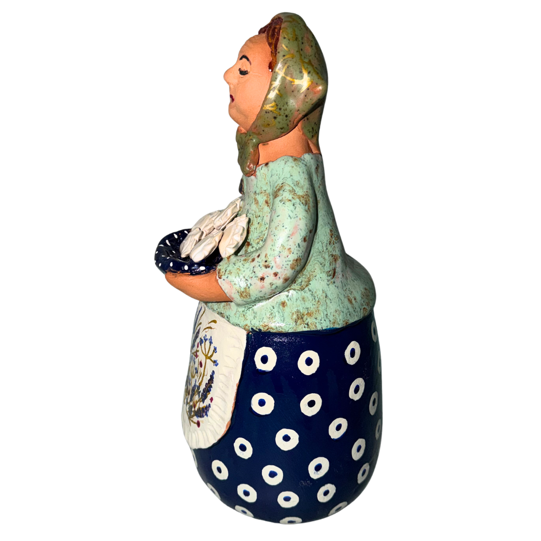 Hand-painted handcrafted babcia figurine holding a bowl of pierogi.