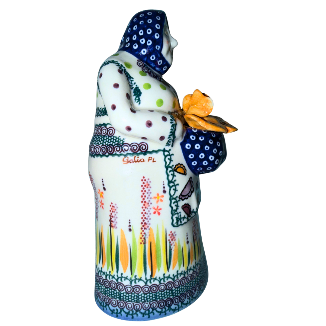 Galia Polish Pottery Babcia holding a bowl of pierogi. 9-inch handmade and hand-painted Polish Grannie figurine from the Bolesławiec region of Poland.