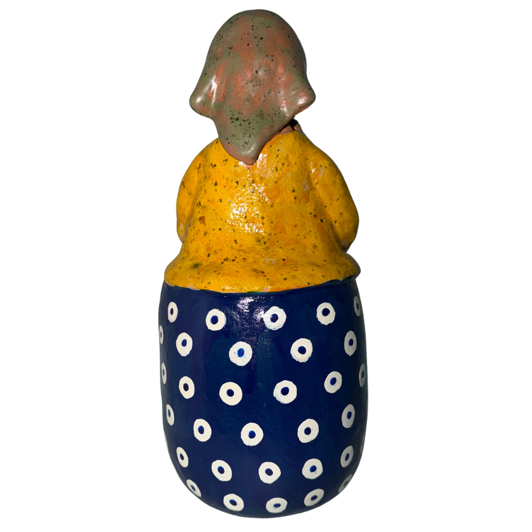 Hand-painted handcrafted babcia figurine holding a bowl of pierogi.