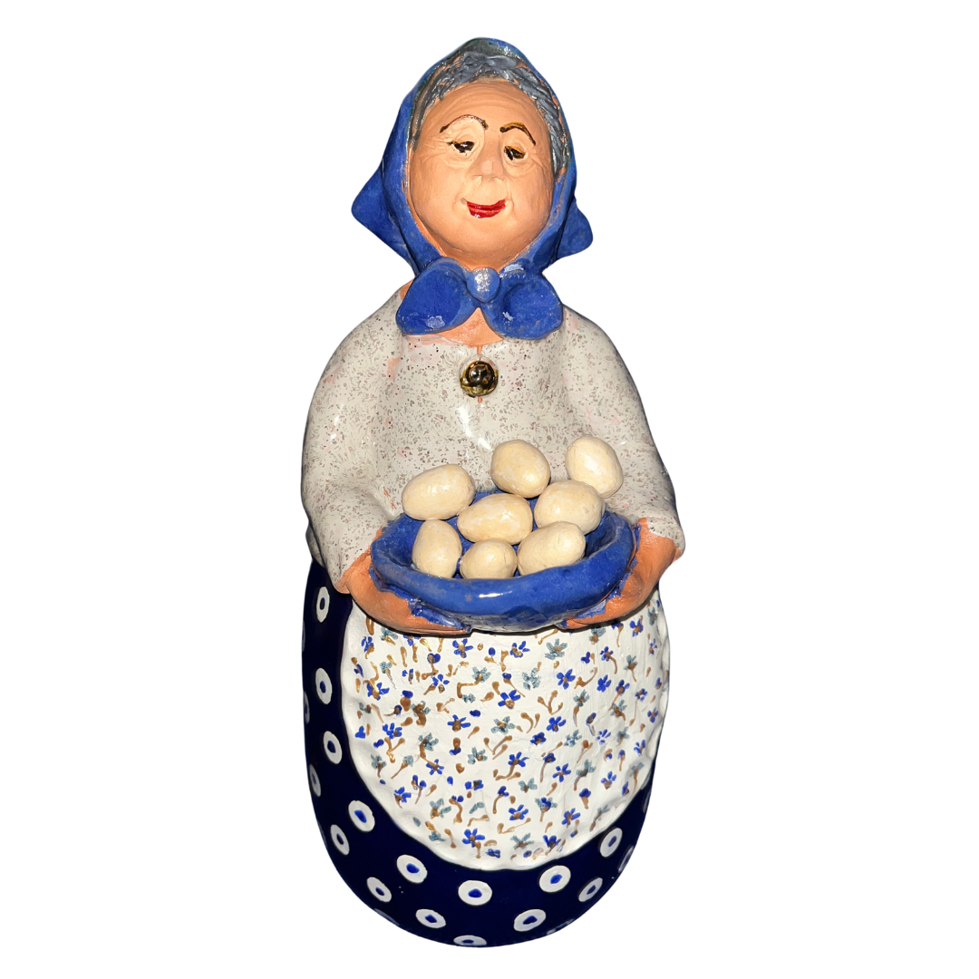 Hand-painted folk art babcia grannie figurine holding a bowl of fresh eggs