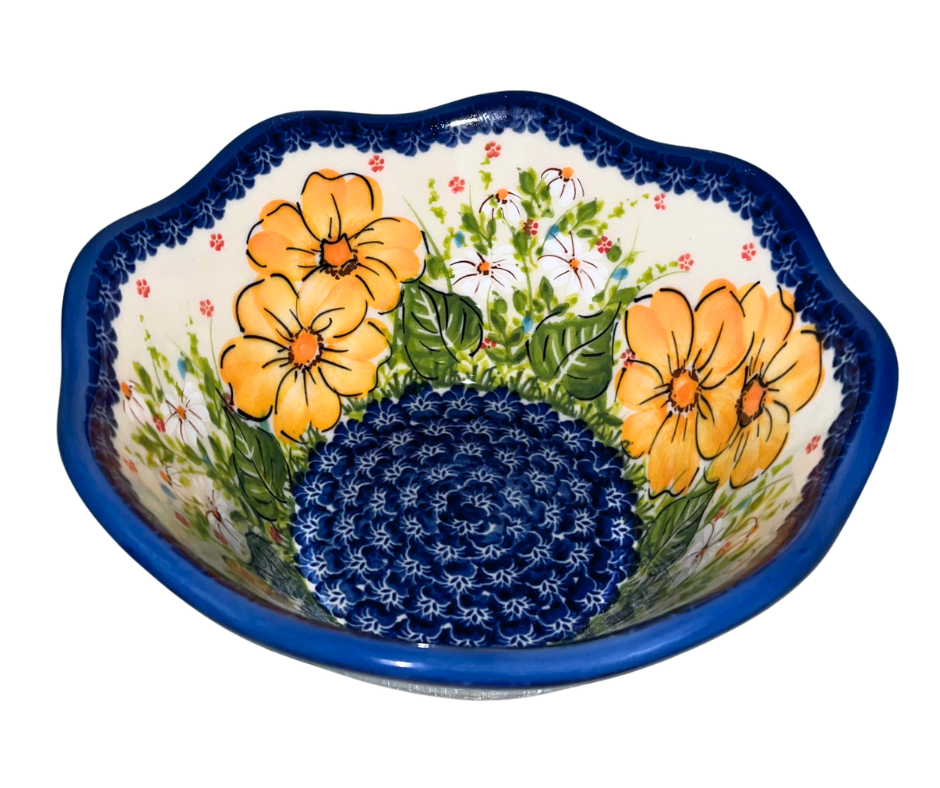 Kalich Polish Pottery floral pattern with golden yellow blossoms, white accents, and green foliage on cream with cobalt rim; hand-painted meadow design with light, airy composition