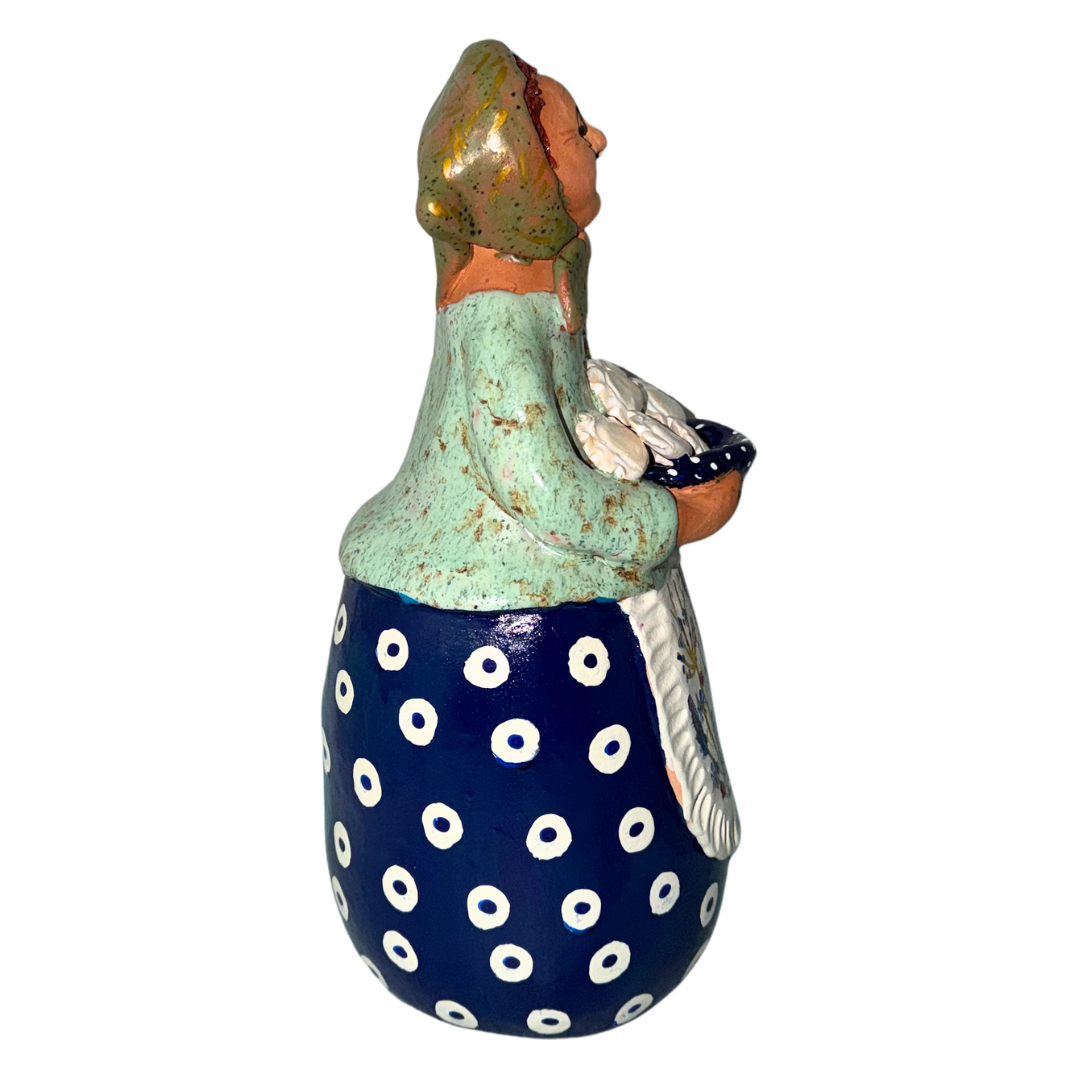 Hand-painted handcrafted babcia figurine holding a bowl of pierogi.